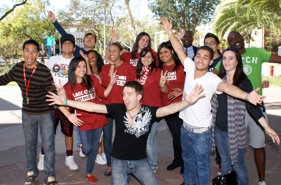 Group of LACC students raising arms