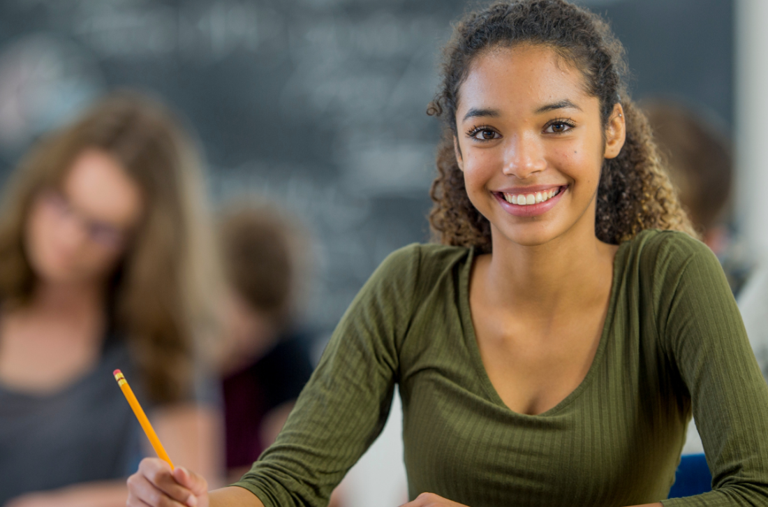 Female student in class listening to lecture