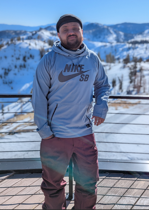 Dr. Simmons standing in front of snow covered mountains 