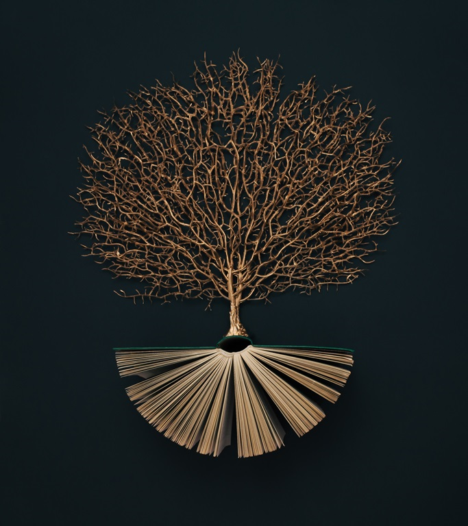 Golden tree growing from the old book